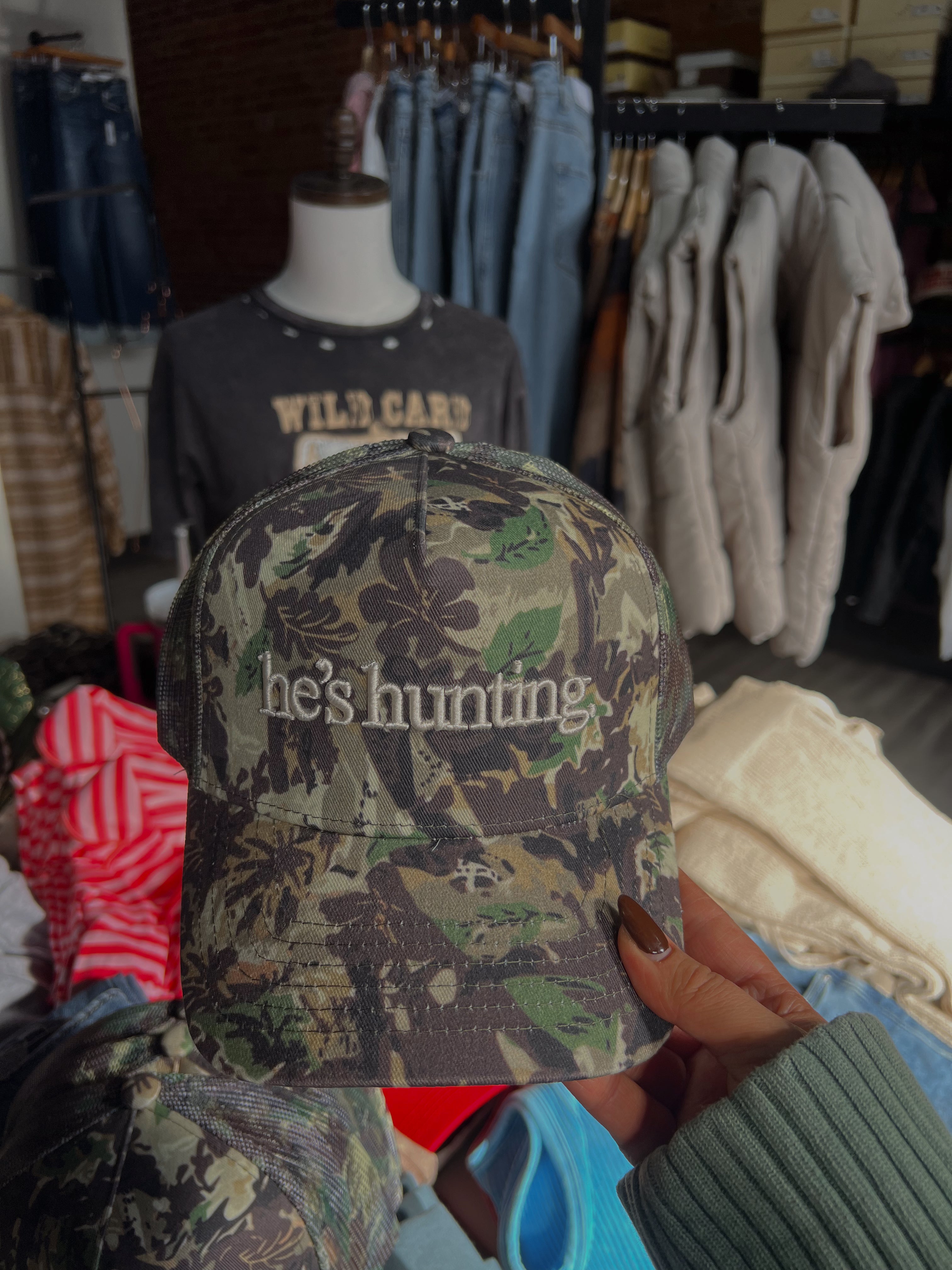 HE’S HUNTING TRUCKER HAT